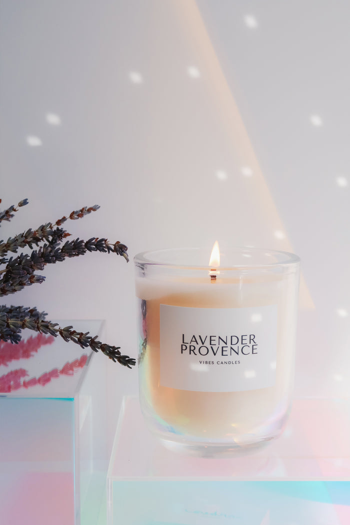 Candle labeled 'Lavender Provence' with lavender flowers on a soft background