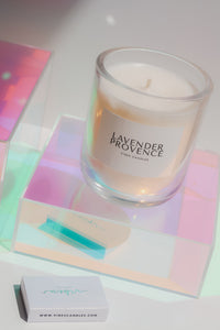Lavender Provence candle on an iridescent riser with a vibes candles matchbox.